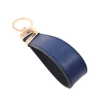 جاکلیدی چرمی مدل لبخند رنگ سرمه ای با پس زمبنه سفید