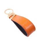 جاکلیدی چرمی مدل لبخند رنگ نارنجی با پس زمبنه سفید